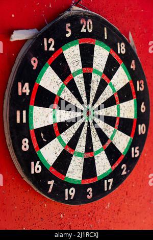 The target of the game of darts on a red background. Concept of success and goal achievement. High quality photo Stock Photo