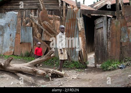 Two brothers by the fence to theior home, Majengo slum, Meru Stock Photo