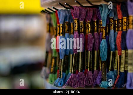 Thame,UK-Sept 2021: Various colors moulin threads hanging on store display, embroidery thread mouline for hobby and craft, popular for knotting Stock Photo