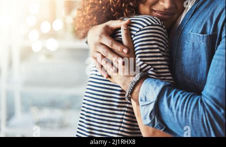 You put your arms around me and Im home. Cropped shot of an unrecognizable couple embracing. Stock Photo