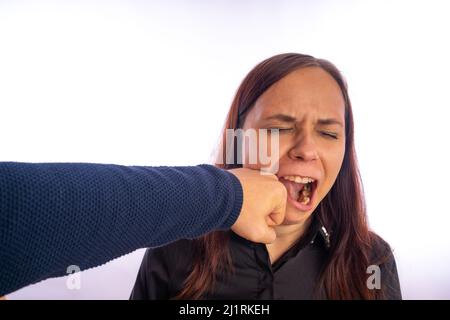 The man hit the female. A man's fist hits a woman in the face. Interpersonal conflict and violence in family. Stock Photo