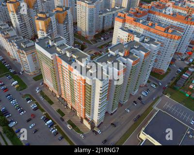 Drone view of new building complex in city center with houses Stock Photo