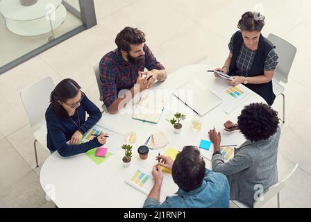 Incorporating all the best ideas into their design solutions. Shot of a group of creative businesspeople having a meeting in an office. Stock Photo