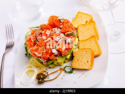 Delicious salmon tartare with avocado, arugula Stock Photo