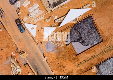 Laying installation of underground utilities in a drainage plastic pipe of pipework being covered in gravel Stock Photo