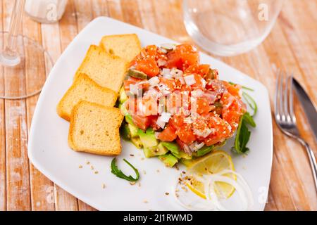 Delicious salmon tartare with avocado, arugula Stock Photo