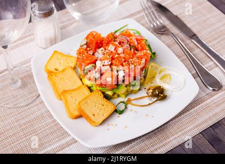 Delicious salmon tartare with avocado, arugula Stock Photo