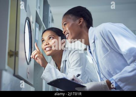 Science illuminates the world. Shot of two scientists working in a lab. Stock Photo