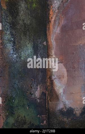 Old brown and cream color concrete wall with imperfections creating a natural design in the stone Stock Photo