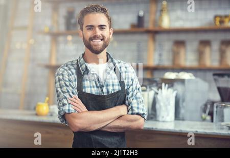 Owning my own store is a fulfilling experience. Portrait of a confident young man working in his store. Stock Photo