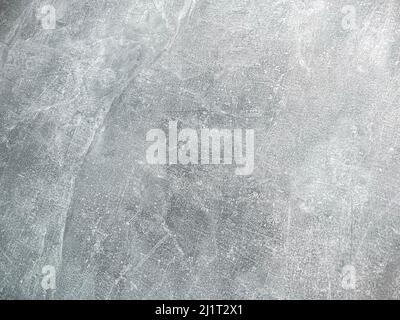 Cement plaster background is gray with lots of scratches and features. Stock Photo