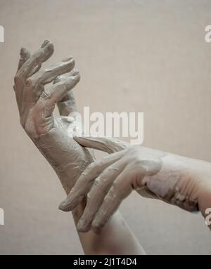 Hands in clay after working at the potter's wheel, close-up Stock Photo