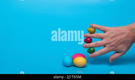 Easter eggs and fingers with quail eggs Stock Photo