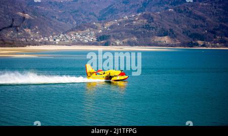 The Canadair of the Fire Brigade, tanker plane supplies itself with water in the lake Stock Photo