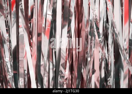 Texture of pink foil for wrapping gifts for the holidays. Abstract festive backgrounds and patterns Stock Photo