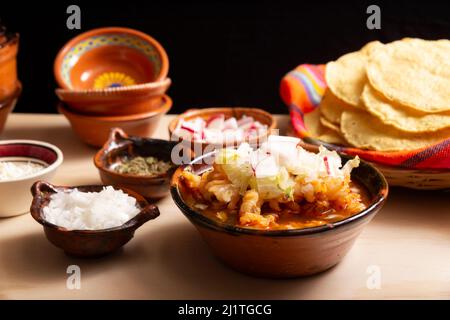 Pozole Rojo. Traditional mexican stew very popular in mexico and neighboring countries. Made from cacahuazintle with meat and various other ingredient Stock Photo