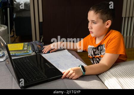 Kid self isolation using tablet for his homework. Online education Stock Photo