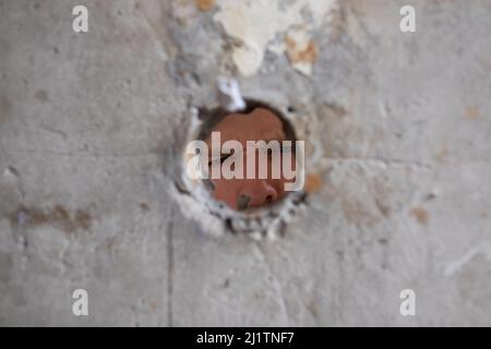 Broken cement wall photo with clipping path of the hole. Stock Photo