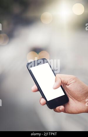 Connected in the city. Cropped shot of an unrecognizable man using a cellphone in the city. Stock Photo