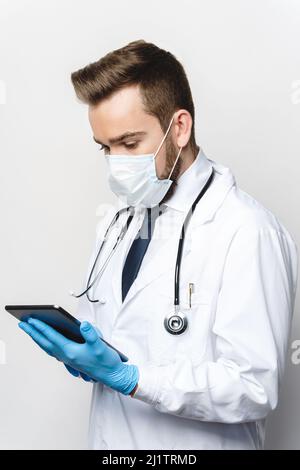 Young and confident doctor is using tablet pc Stock Photo