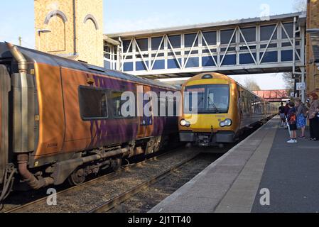 Passengers wait on the platform at Kidderminster Railway Station as a West Midlands Railway Class 172 Turbostar train arrives at the platform, 03/22 Stock Photo