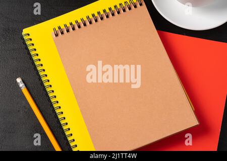 Three notepads on a black table close up Stock Photo