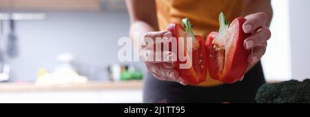Woman holding sliced bell peppers close up Stock Photo