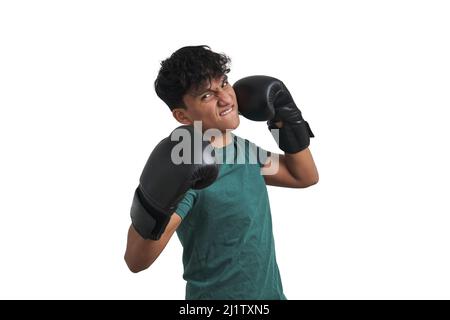 Young peruvian boxer throwing a chopping right, isolated. Stock Photo