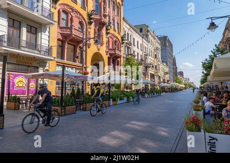 Lodz, Poland - August 7, 2020: Famous Piotrkowska Street with historic buildings, cafes, shops, city landmark and major tourist attraction. Stock Photo