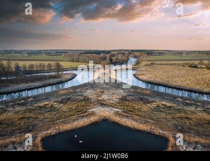 Sunset over a small river in the spring evening. Stock Photo