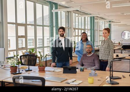 Confident group of young businesspeople working together in an office Stock Photo