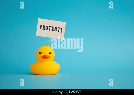 Protester rubber duck carries a signboard with the word protest. Activism and political protest concept. Stock Photo