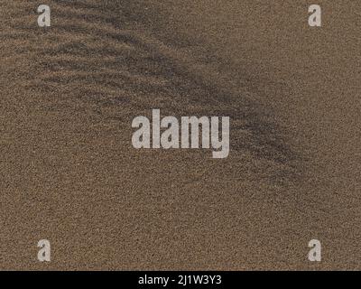 High angle closeup view of a texture of sand grains in natural reserve Dunas de Maspalomas, southern Gran Canaria, Canary Islands, Spain with texture. Stock Photo