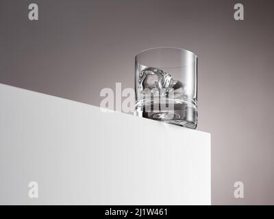 Empty whiskey glass with ice cubes ready to be filled. on white wooden box. Hard drink concept. Stock Photo