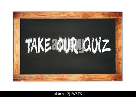 TAKE  OUR  QUIZ text written on black wooden frame school blackboard. Stock Photo