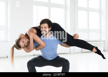 Fitness couple during calisthenics workout in the gym Stock Photo