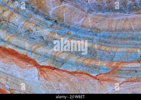 Textured surface of natural massive beige and gray stone with stripes and scratches as abstract background Stock Photo