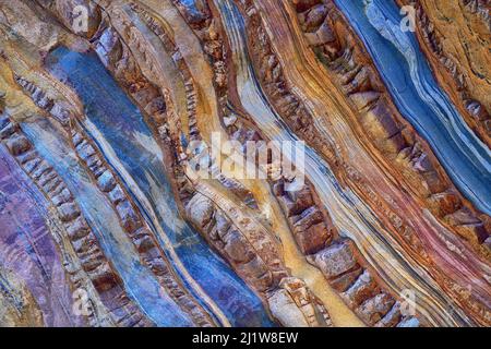 Textured surface of natural massive beige and blue stone with stripes and scratches as abstract background Stock Photo