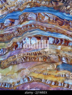 Textured surface of natural massive beige and gray stone with stripes and scratches as abstract background Stock Photo