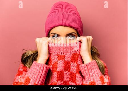 African American female with paper bag of fresh green beetroot looking at camera while standing on the street Stock Photo