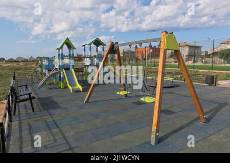 Swings on the playground along Kirov street in the village of Uyutnoye, Saksky district, Evpatoria, Crimea, Russia Stock Photo