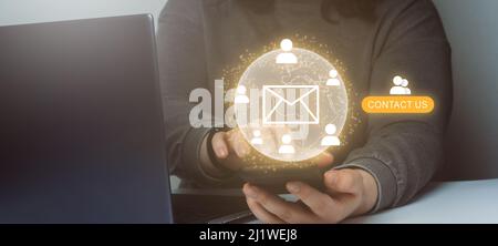 Business woman showing a global contact connection on smartphone. Contact us or Customer support concept. Stock Photo