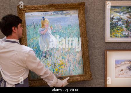 London, UK.  28 March 2022. A technician hangs “One o'clock, two o'clock” by Dorothea Sharp (Est. £20,000 - £30,000) at a preview of Bonhams’ 19th Century and British Impressionist Art sale which will take place at their Bonhams’ New Bond Street galleries on 30 March.  Credit: Stephen Chung / Alamy Live News Stock Photo