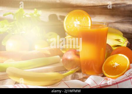 Delicious fruit smoothie made from fresh fruits. A glass of freshly made smoothie. Sunshine. Background with copy space Stock Photo
