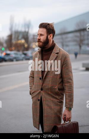 Business portrait of standing man in outdoor. Looking away. Vertical image. Stock Photo