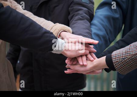 Multiracial group of friends with hands in stack. Teamwork concept. Stock Photo