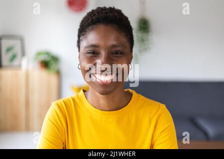 Portrait screen view of smiling millennial african woman on video call at home Stock Photo