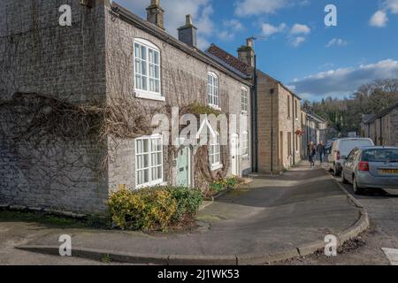 Row of local stone built houses on Fennel St. in the Derbyshire village of Ashford in the Water. Stock Photo