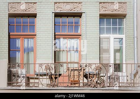 Stylish balcony with a metal railing, solid architectural elemen. A fragment of the facade of an apartment building, an open view of the balcony, equi Stock Photo