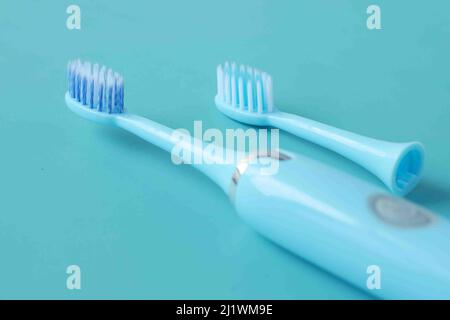 a blue color electronic toothbrushes on blue background  Stock Photo